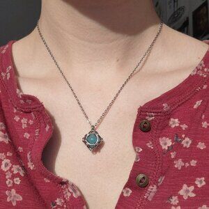 Aquamarine blue caged pearl necklace with a small silver chain